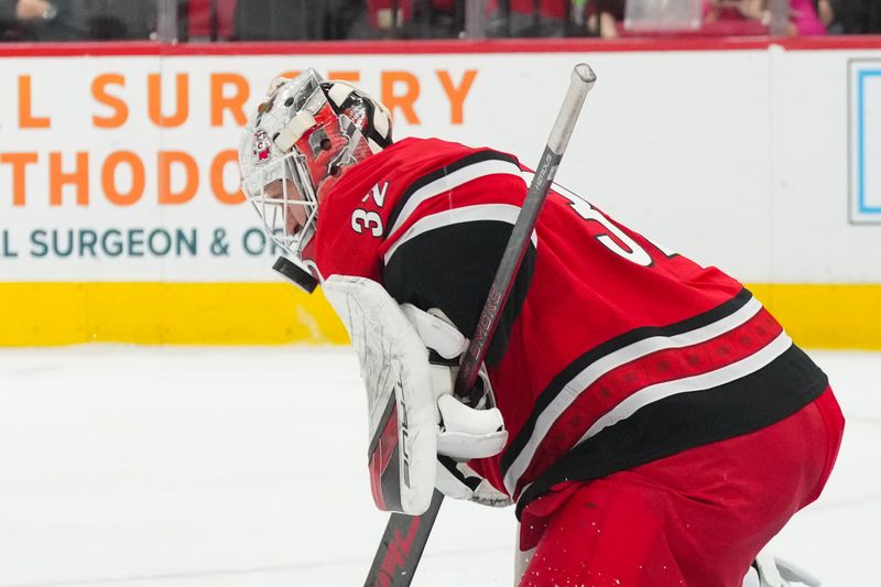 Dec 9, 2025; Raleigh, North Carolina, USA;  Carolina Hurricanes goaltender Brandon Bussi (32) makes a save against the Columbus Blue Jackets during the second period at Lenovo Center. Mandatory Credit: James Guillory-Imagn Images