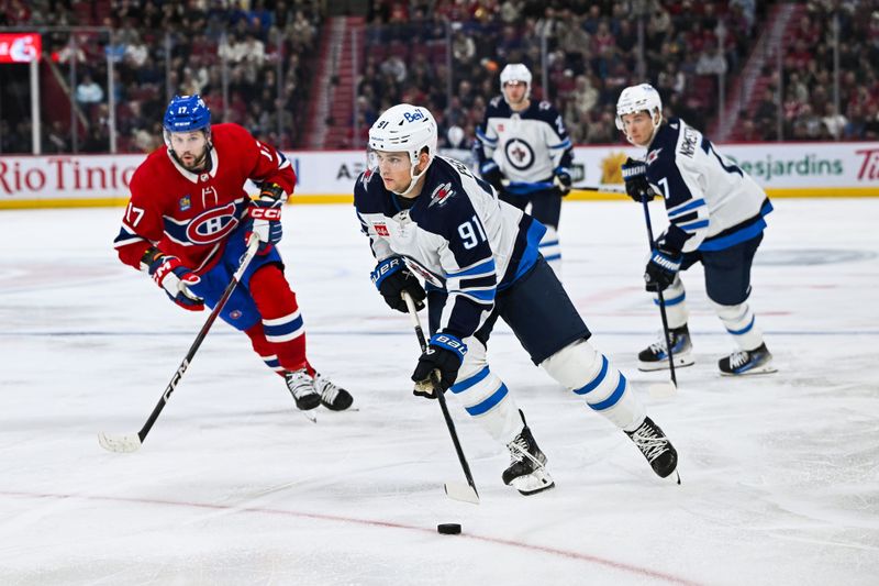 Oct 28, 2023; Montreal, Quebec, CAN; Montreal Canadiens center Sean Monahan (91) plays the puck against the Montreal Canadiens during the third period at Bell Centre. Mandatory Credit: David Kirouac-USA TODAY Sports