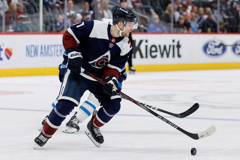 Apr 13, 2024; Denver, Colorado, USA; Colorado Avalanche defenseman Devon Toews (7) controls the puck in the third period against the Winnipeg Jets at Ball Arena. Mandatory Credit: Isaiah J. Downing-USA TODAY Sports