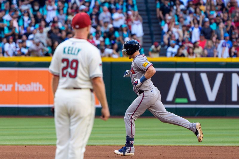 Apr 26, 2025; Phoenix, Arizona, USA;  Atlanta Braves catcher Sean Murphy (12) is watched with Arizona Diamondbacks pitcher Merrill Kelly (29) after hitting a home run in the second inning against the Arizona Diamondbacks at Chase Field. Mandatory Credit: Allan Henry-Imagn Images