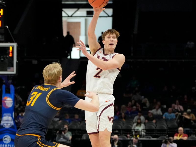 Mar 11, 2025; Charlotte, NC, USA; Virginia Tech Hokies guard Jaden Schutt (2) passes the ball as California Golden Bears forward Rytis Petraitis (31) defends in the first half at Spectrum Center. Mandatory Credit: Bob Donnan-Imagn Images