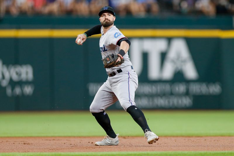 Aug 6, 2023; Arlington, Texas, USA; Miami Marlins shortstop Jon Berti (5) fields a ground ball during the first inning against the Texas Rangers at Globe Life Field. Mandatory Credit: Andrew Dieb-USA TODAY Sports