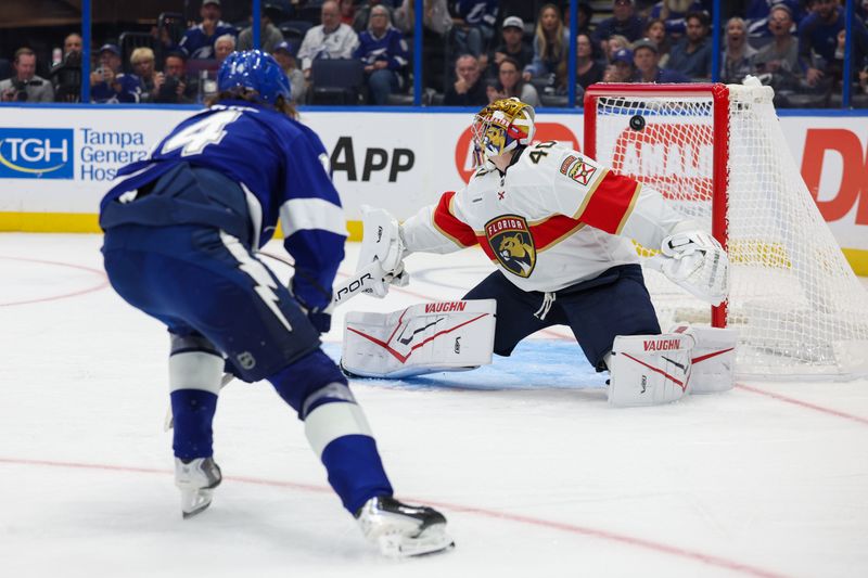 Oct 2, 2025; Tampa, Florida, USA; Tampa Bay Lightning center Conor Geekie (14) scores a goal past Florida Panthers goaltender Daniil Tarasov (40) in the third period  at Benchmark International Arena. Mandatory Credit: Nathan Ray Seebeck-Imagn Images