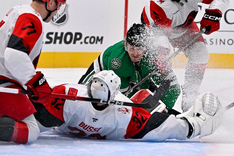 Oct 25, 2025; Dallas, Texas, USA; Carolina Hurricanes goaltender Brandon Bussi (32) stops a shot by Dallas Stars center Roope Hintz (24) during the second period at the American Airlines Center. Mandatory Credit: Jerome Miron-Imagn Images