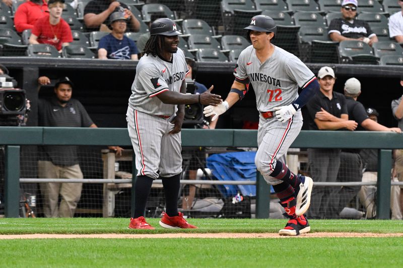 Jul 10, 2024; Chicago, Illinois, USA;  Minnesota Twins third base Brooks Lee (72) high fives third base coach/outfield coach Tommy Watkins (40) after hitting a home run against the Chicago White Sox during the sixth inning at Guaranteed Rate Field. Mandatory Credit: Matt Marton-USA TODAY Sports