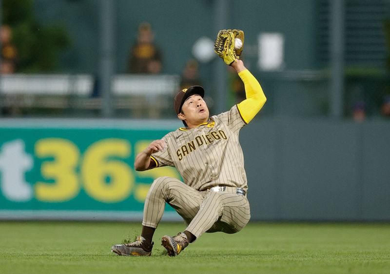 Apr 22, 2024; Denver, Colorado, USA; San Diego Padres shortstop Ha-Seong Kim (7) makes a catch as he falls down in the fifth inning against the Colorado Rockies at Coors Field. Mandatory Credit: Isaiah J. Downing-USA TODAY Sports