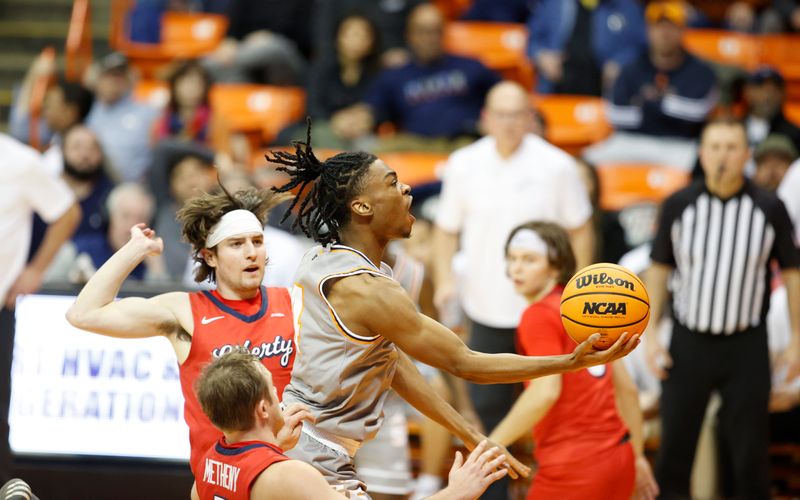 Feb 3, 2024; El Paso, Texas, USA; UTEP Miners guard Corey Camper Jr. (4) goes for a layup against the Liberty University Flames defense in the second half at Don Haskins Center. Mandatory Credit: Ivan Pierre Aguirre-USA TODAY Sports