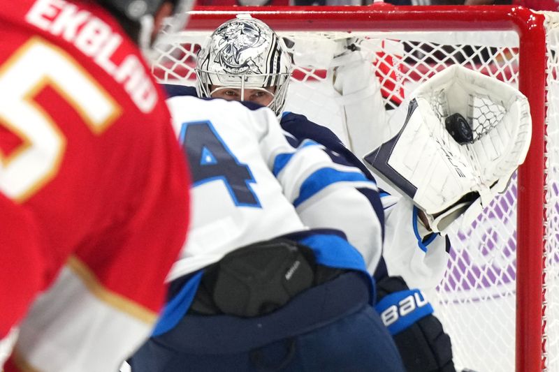 Nov 16, 2024; Sunrise, Florida, USA;  Winnipeg Jets goaltender Connor Hellebuyck (37) makes a save through traffic against the Florida Panthers during the second period at Amerant Bank Arena. Mandatory Credit: Jim Rassol-Imagn Images