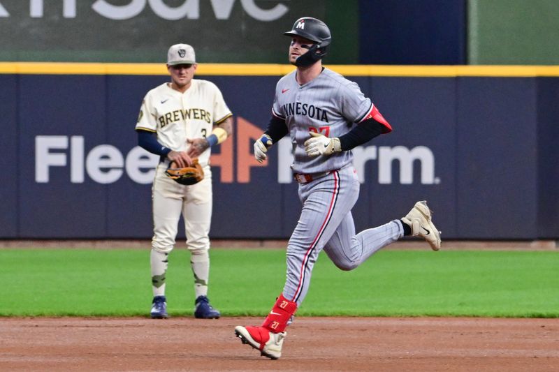 May 17, 2025; Milwaukee, Wisconsin, USA; Minnesota Twins designated hitter Ryan Jeffers (27) runs the bases after hitting a solo home run as Milwaukee Brewers shortstop Joseph Ortiz (3) looks on in the first inning at American Family Field. Mandatory Credit: Benny Sieu-Imagn Images