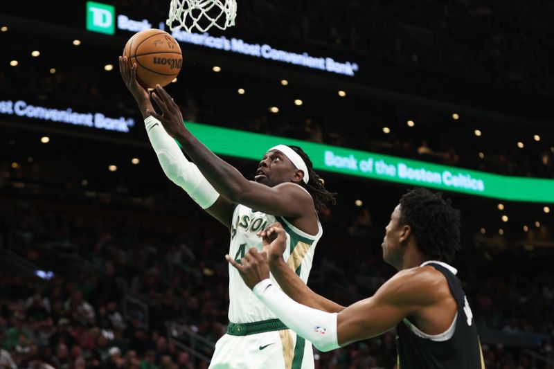 BOSTON, MASSACHUSETTS - FEBRUARY 04: Jrue Holiday #4 of the Boston Celtics shoots the ball during the first half against the Memphis Grizzlies at TD Garden on February 04, 2024 in Boston, Massachusetts. NOTE TO USER: User expressly acknowledges and agrees that, by downloading and or using this photograph, User is consenting to the terms and conditions of the Getty Images License Agreement. (Photo by Paul Rutherford/Getty Images)