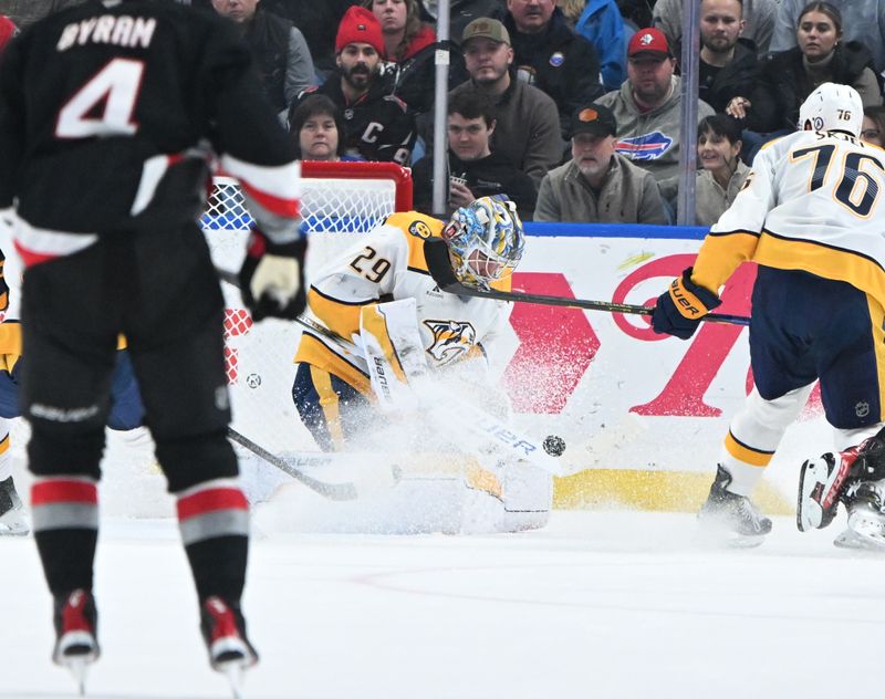 Jan 31, 2025; Buffalo, New York, USA; Nashville Predators goaltender Justus Annunen (29) blocks a shot on goal by the Buffalo Sabres in the third period at the KeyBank Center. Mandatory Credit: Mark Konezny-Imagn Images