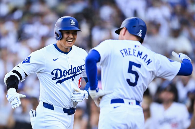 Jul 21, 2024; Los Angeles, California, USA; Los Angeles Dodgers designated hitter Shohei Ohtani (17) celebrates with Los Angeles Dodgers first baseman Freddie Freeman (5) after hitting a home run against the Boston Red Sox during the fifth inning at Dodger Stadium. Mandatory Credit: Jonathan Hui-USA TODAY Sports