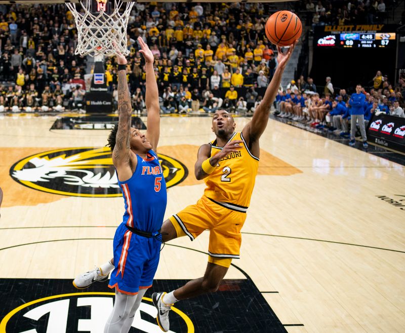 Jan 20, 2024; Columbia, Missouri, USA; Missouri Tigers guard Tamar Bates (2) shoots against Florida Gators guard Will Richard (5) during the second half at Mizzou Arena. Mandatory Credit: Jay Biggerstaff-USA TODAY Sports