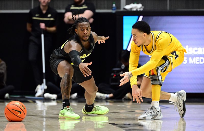 Jan 23, 2024; West Lafayette, Indiana, USA; Michigan Wolverines guard Jaelin Llewellyn (3) passes the ball away from Purdue Boilermakers guard Lance Jones (55) during the second half at Mackey Arena. Mandatory Credit: Marc Lebryk-USA TODAY Sports