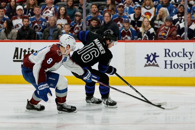 Feb 24, 2024; Denver, Colorado, USA; Toronto Maple Leafs right wing Mitchell Marner (16) controls the puck as Colorado Avalanche defenseman Cale Makar (8) defends in the first period at Ball Arena. Mandatory Credit: Isaiah J. Downing-USA TODAY Sports