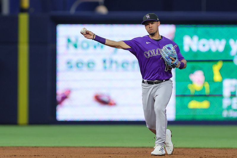 Jul 22, 2023; Miami, Florida, USA; Colorado Rockies shortstop Ezequiel Tovar (14) throws the baseball to first during the third inning at loanDepot Park. Mandatory Credit: Sam Navarro-USA TODAY Sports