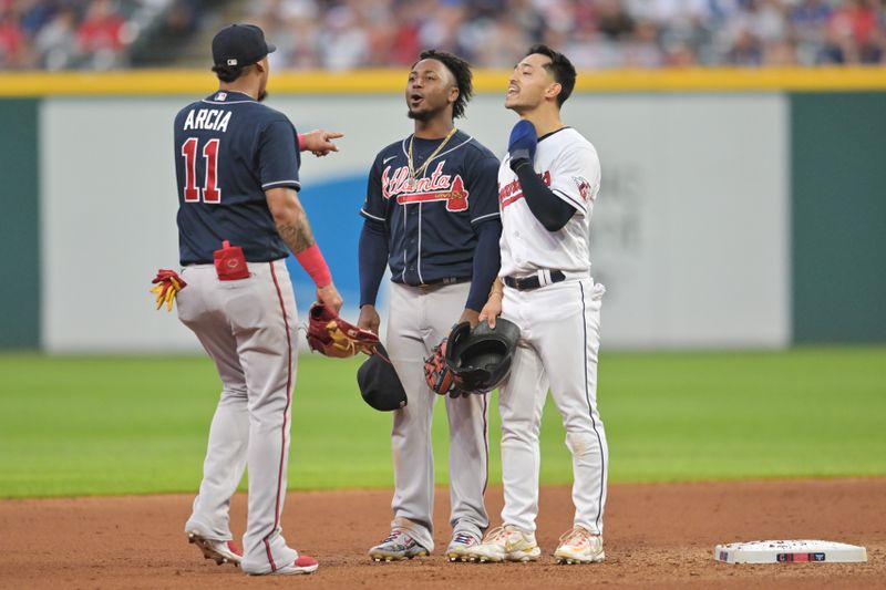 Jul 3, 2023; Cleveland, Ohio, USA; Atlanta Braves shortstop Orlando Arcia (11) and second baseman Ozzie Albies (1) and Cleveland Guardians left fielder Steven Kwan (38) joke around during the seventh inning at Progressive Field. Mandatory Credit: Ken Blaze-USA TODAY Sports