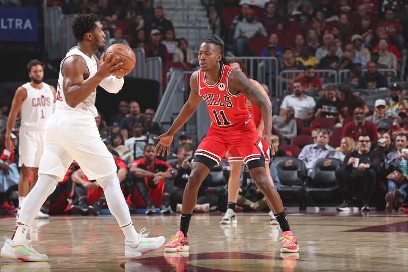 CLEVELAND, OH - OCTOBER 8: Ayo Dosunmu #11 of the Chicago Bulls plays defense against the Cleveland Cavaliers on October 8, 2024 at Rocket Mortgage FieldHouse in Cleveland, Ohio. NOTE TO USER: User expressly acknowledges and agrees that, by downloading and/or using this Photograph, user is consenting to the terms and conditions of the Getty Images License Agreement. Mandatory Copyright Notice: Copyright 2024 NBAE (Photo by Jeff Haynes/NBAE via Getty Images)