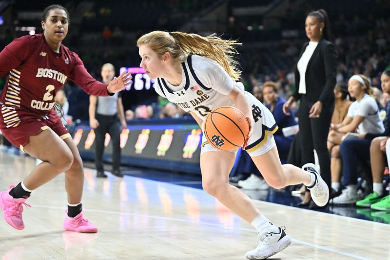 Jan 11, 2024; South Bend, Indiana, USA; Notre Dame Fighting Irish guard Anna Dewolfe (13) dribbles past Boston College Eagles guard Kaylah Ivey (2) in the second half at the Purcell Pavilion. Mandatory Credit: Matt Cashore-USA TODAY Sports