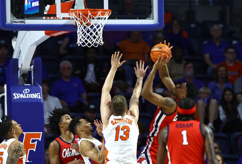 Feb 15, 2023; Gainesville, Florida, USA; Mississippi Rebels forward Robert Allen (21) shoots over Florida Gators forward Aleks Szymczyk (13) during the second half at Exactech Arena at the Stephen C. O'Connell Center. Mandatory Credit: Kim Klement-USA TODAY Sports