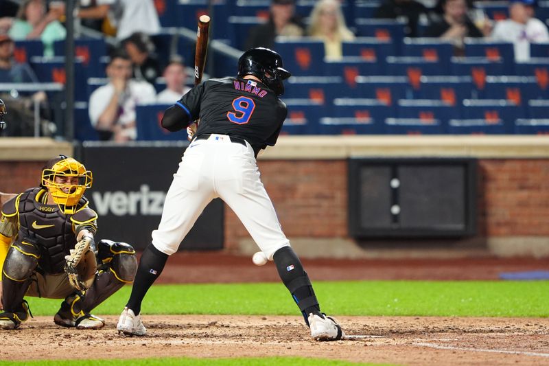 Jun 14, 2024; New York City, New York, USA; New York Mets left fielder Brandon Nimmo (9) gets hit by a pitch against the San Diego Padres during the sixth inning at Citi Field. Mandatory Credit: Gregory Fisher-USA TODAY Sports