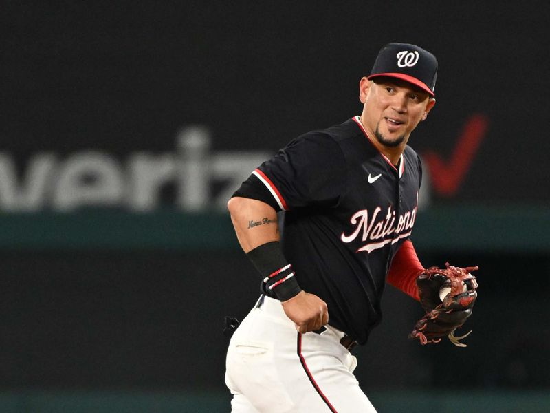 Jul 2, 2024; Washington, District of Columbia, USA; Washington Nationals second baseman Ildemaro Vargas (14) smiles as he jogs off the field against the New York Mets during the ninth inning at Nationals Park. Mandatory Credit: Rafael Suanes-USA TODAY Sports