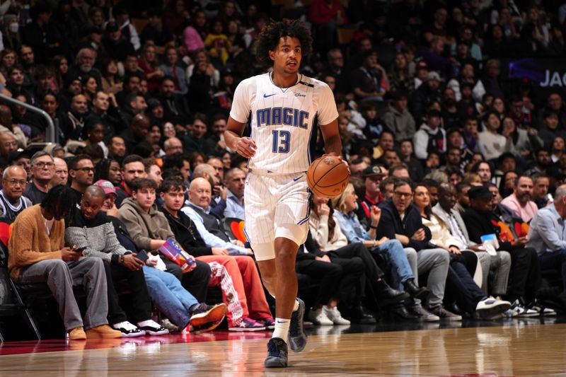 TORONTO, CANADA - JANUARY 3: Jett Howard #13 of the Orlando Magic brings the ball up court during the game against the Toronto Raptors on January 3, 2025 at the Scotiabank Arena in Toronto, Ontario, Canada.  NOTE TO USER: User expressly acknowledges and agrees that, by downloading and or using this Photograph, user is consenting to the terms and conditions of the Getty Images License Agreement.  Mandatory Copyright Notice: Copyright 2025 NBAE(Photo by Mark Blinch/NBAE via Getty Images)