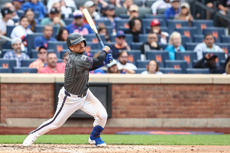 Sep 7, 2024; New York City, New York, USA;  New York Mets second baseman Jose Iglesias (11) hits a single in the fifth inning against the Cincinnati Reds at Citi Field. Mandatory Credit: Wendell Cruz-Imagn Images