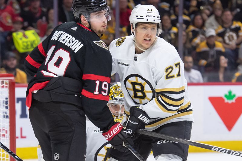 Jan 25, 2024; Ottawa, Ontario, CAN; Ottawa Senators right wing Drake Batherson (19) battles with Boston Bruins defenseman Hampus Lindholm (27) in the second period at Canadian Tire Centre. Mandatory Credit: Marc DesRosiers-USA TODAY Sports