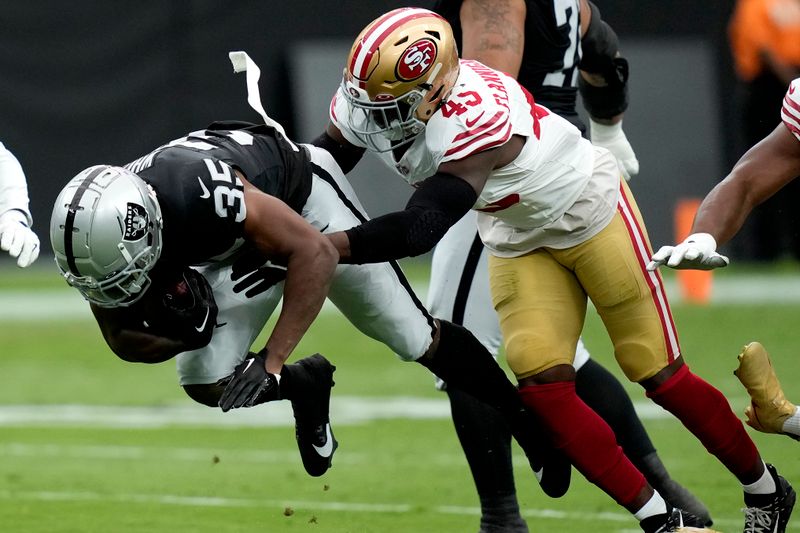 Las Vegas Raiders running back Zamir White (35) is hit by San Francisco 49ers linebacker Demetrius Flannigan-Fowles (45) during the first half of an NFL preseason football game, Sunday, Aug. 13, 2023, in Las Vegas. (AP Photo/John Locher)