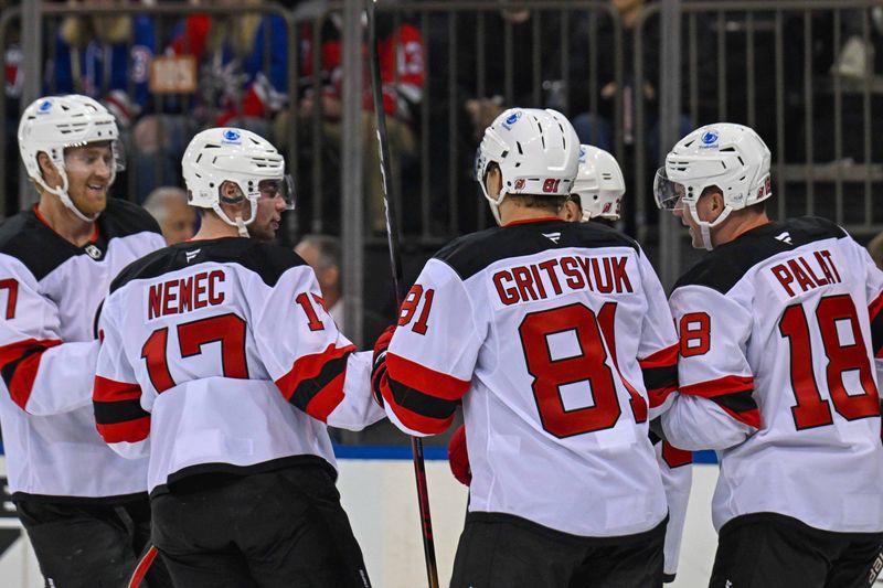 Oct 2, 2025; New York, New York, USA;  New Jersey Devils left wing Ondrej Palat (18) celebrates his goal against the New York Rangers with New Jersey Devils right wing Arseny Gritsyuk (81) and New Jersey Devils defenseman Simon Nemec (17) during the third period at Madison Square Garden. Mandatory Credit: Dennis Schneidler-Imagn Images