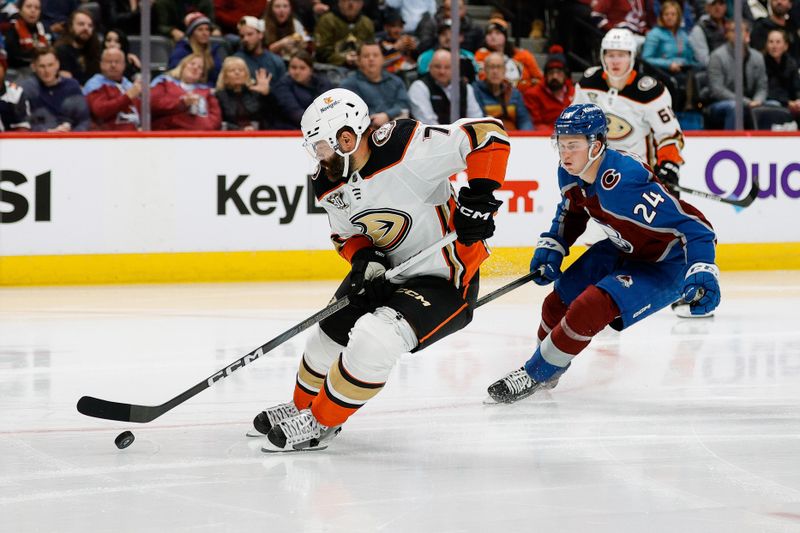 Dec 5, 2023; Denver, Colorado, USA; Anaheim Ducks defenseman Radko Gudas (7) controls the puck ahead of Colorado Avalanche right wing Oskar Olausson (24) in the second period at Ball Arena. Mandatory Credit: Isaiah J. Downing-USA TODAY Sports