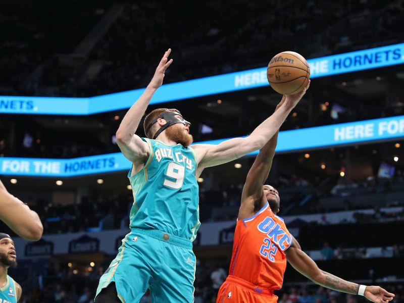 CHARLOTTE, NC - APRIL 7: Davis Bertans #9 of the Charlotte Hornets rebounds the ball during the game against the Oklahoma City Thunder on April 7, 2024 at Spectrum Center in Charlotte, North Carolina. NOTE TO USER: User expressly acknowledges and agrees that, by downloading and or using this photograph, User is consenting to the terms and conditions of the Getty Images License Agreement.  Mandatory Copyright Notice:  Copyright 2024 NBAE (Photo by Brock Williams-Smith/NBAE via Getty Images)