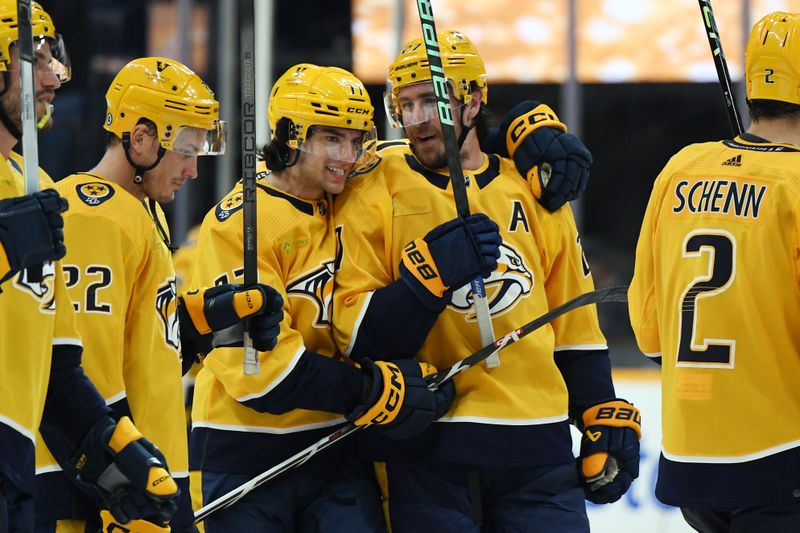 Feb 10, 2024; Nashville, Tennessee, USA; Nashville Predators defenseman Ryan McDonagh (27) and right wing Luke Evangelista (77) celebrate after an overtime win against the Arizona Coyotes at Bridgestone Arena. Mandatory Credit: Christopher Hanewinckel-USA TODAY Sports