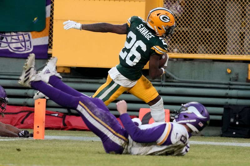 Green Bay Packers safety Darnell Savage (26) returns an interception 75 yards for a touchdown over Minnesota Vikings quarterback Kirk Cousins during the first half of an NFL football game, Sunday, Jan. 1, 2023, in Green Bay, Wis. (AP Photo/Morry Gash)