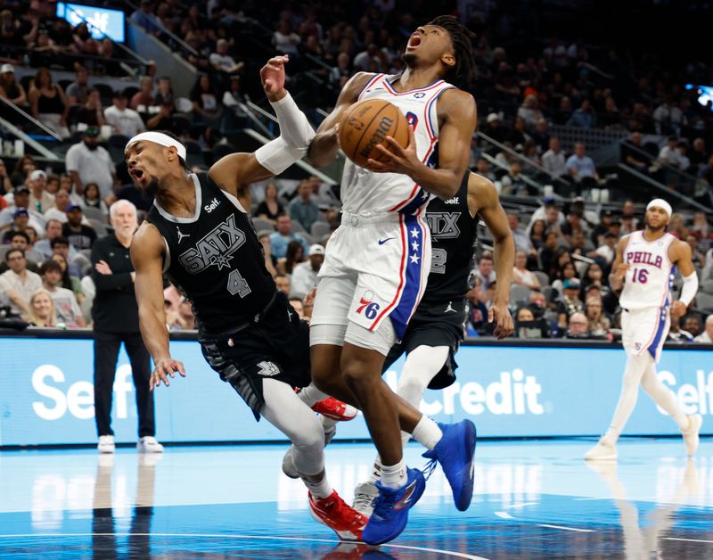 SAN ANTONIO, TX - APRIL 07: Devonte Graham #4 of the San Antonio Spurs is fouled by Tyrese Maxey #0 of the Philadelphia 76ers in the second half at Frost Bank Center on April 7, 2024 in San Antonio, Texas. NOTE TO USER: User expressly acknowledges and agrees that, by downloading and or using this photograph, User is consenting to terms and conditions of the Getty Images License Agreement. (Photo by Ronald Cortes/Getty Images)