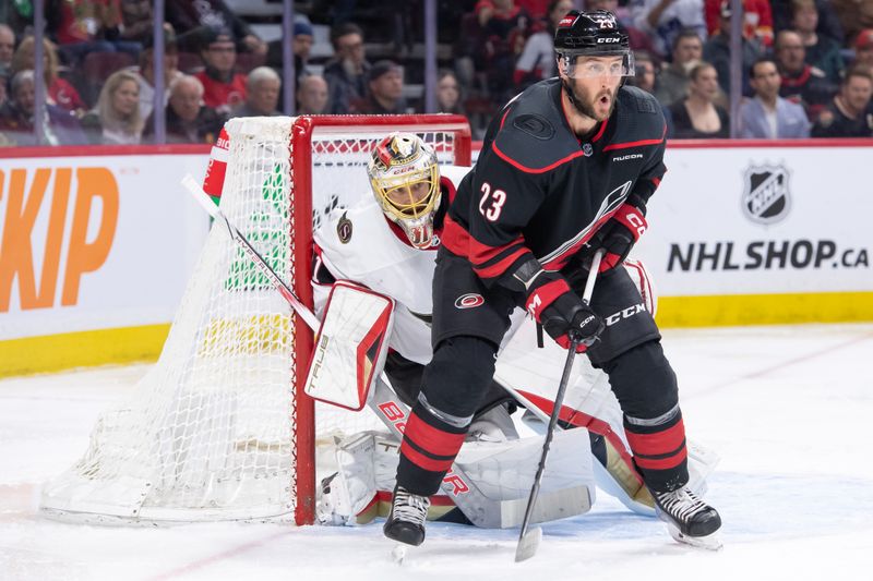 Mar 17, 2024; Ottawa, Ontario, CAN; Carolina Hurricanes right wing Stefan Noesen (23) screens Ottawa Senators goalie Anton Forsberg (31) in the second period at the Canadian Tire Centre. Mandatory Credit: Marc DesRosiers-USA TODAY Sports