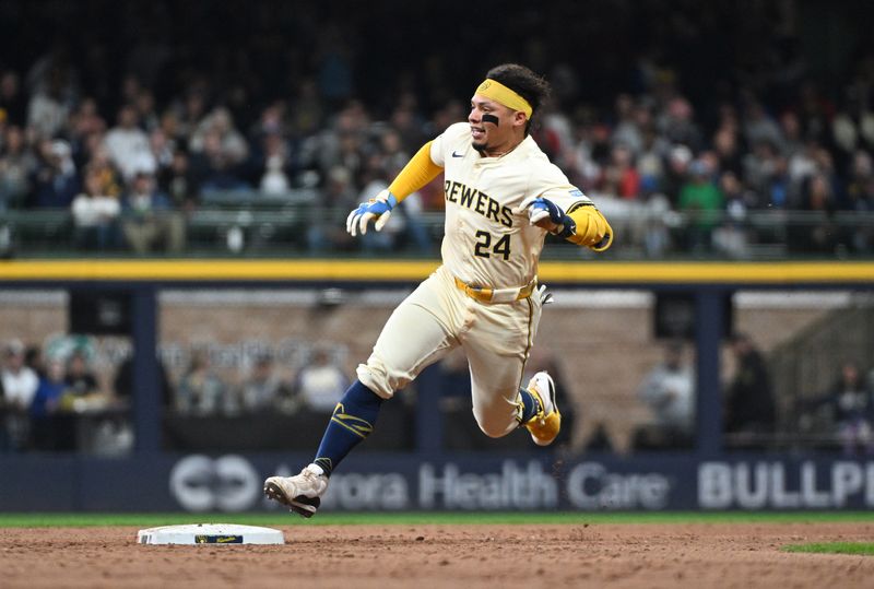 Apr 26, 2024; Milwaukee, Wisconsin, USA;  Milwaukee Brewers catcher William Contreras (24) hits a double and thinks about heading to third against the New York Yankees in the seventh inning at American Family Field. Mandatory Credit: Michael McLoone-USA TODAY Sports