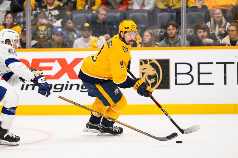 Nov 29, 2024; Nashville, Tennessee, USA;  Nashville Predators left wing Filip Forsberg (9) skates with the puck against the Tampa Bay Lightning during the second period at Bridgestone Arena. Mandatory Credit: Steve Roberts-Imagn Images