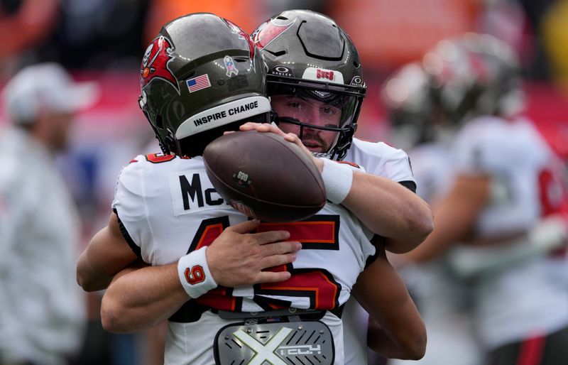 Tampa Bay Buccaneers quarterback Baker Mayfield hugs wide receiver Jalen McMillan (15) before an NFL football game against the New York Giants Sunday, Nov. 24, 2024, in East Rutherford, N.J. (AP Photo/Seth Wenig)