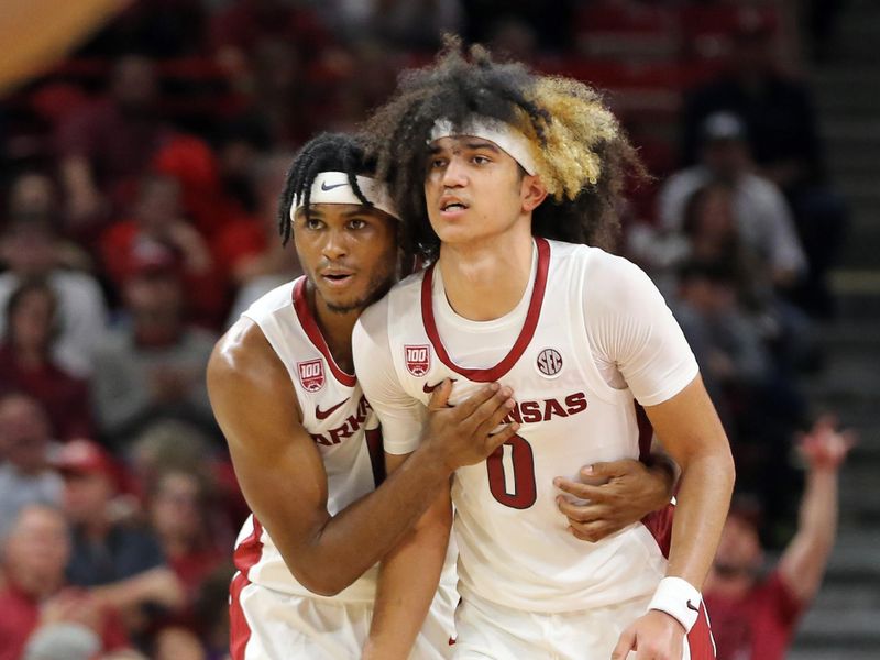 Nov 28, 2022; Fayetteville, Arkansas, USA; Arkansas Razorbacks guards Ricky Council IV (1) and Anthony Black (0) celebrate int he second half against the Troy Trojans at Bud Walton Arena. Arkansas won 74-61. Mandatory Credit: Nelson Chenault-USA TODAY Sports