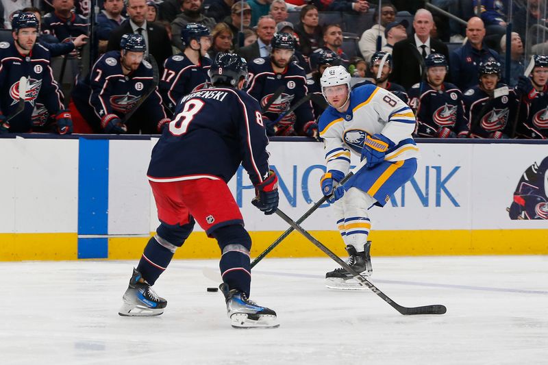 Apr 10, 2025; Columbus, Ohio, USA; Buffalo Sabres center Sam Lafferty (81) carries the puck as Columbus Blue Jackets defenseman Zach Werenski (8) defends during the third period at Nationwide Arena. Mandatory Credit: Russell LaBounty-Imagn Images