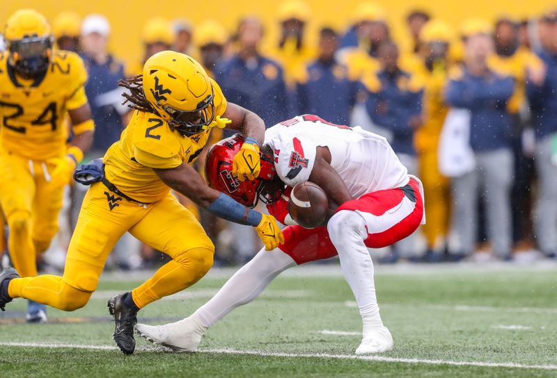 Sep 23, 2023; Morgantown, West Virginia, USA; West Virginia Mountaineers safety Aubrey Burks (2) breaks up a pass intended for Texas Tech Red Raiders wide receiver Loic Fouonji (11) during the second quarter at Mountaineer Field at Milan Puskar Stadium. Mandatory Credit: Ben Queen-USA TODAY Sports