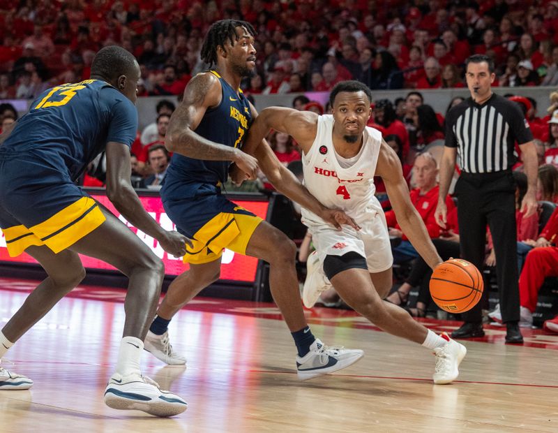 Jan 6, 2024; Houston, Texas, USA;Houston Cougars guard L.J. Cryer (4) dribbles against West Virginia Mountaineers guard Kobe Johnson (2) in the second half at Fertitta Center. Mandatory Credit: Thomas Shea-USA TODAY Sports