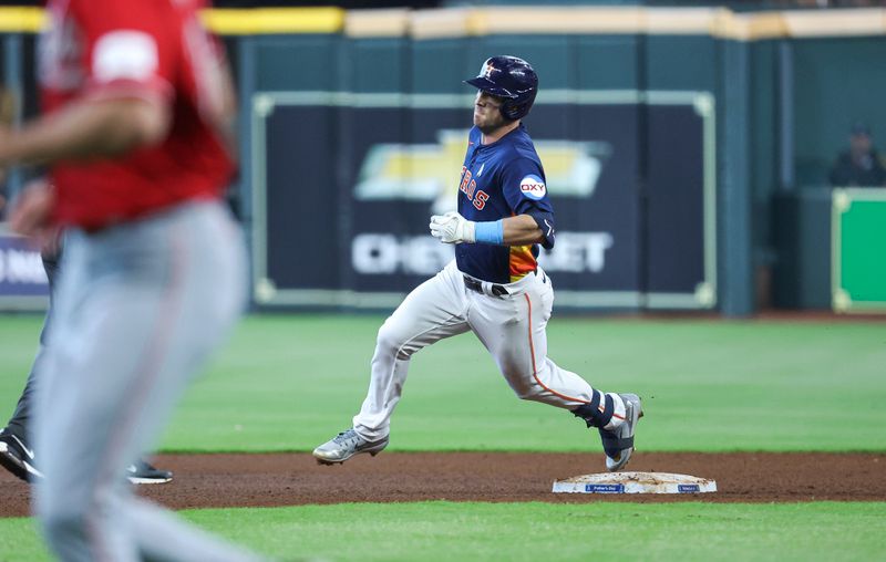 Jun 18, 2023; Houston, Texas, USA; Houston Astros third baseman Alex Bregman (2) rounds second base on a triple during the fourth inning against the Cincinnati Reds at Minute Maid Park. Mandatory Credit: Troy Taormina-USA TODAY Sports