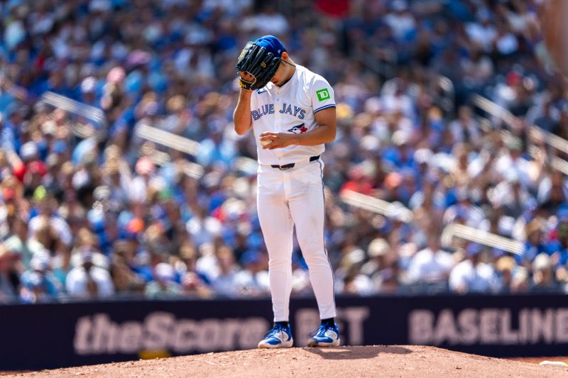 Jul 20, 2024; Toronto, Ontario, CAN; Toronto Blue Jays pitcher Yusei Kikuchi (16) covers his head with his glove during the first inning against the Detroit Tigers at Rogers Centre. Mandatory Credit: Kevin Sousa-USA TODAY Sports