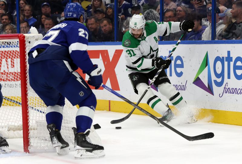 Oct 30, 2025; Tampa, Florida, USA; Dallas Stars center Tyler Seguin (91) skates with the puck as Tampa Bay Lightning defenseman Ryan McDonagh (27) defends during the second period at Benchmark International Arena. Mandatory Credit: Kim Klement Neitzel-Imagn Images
