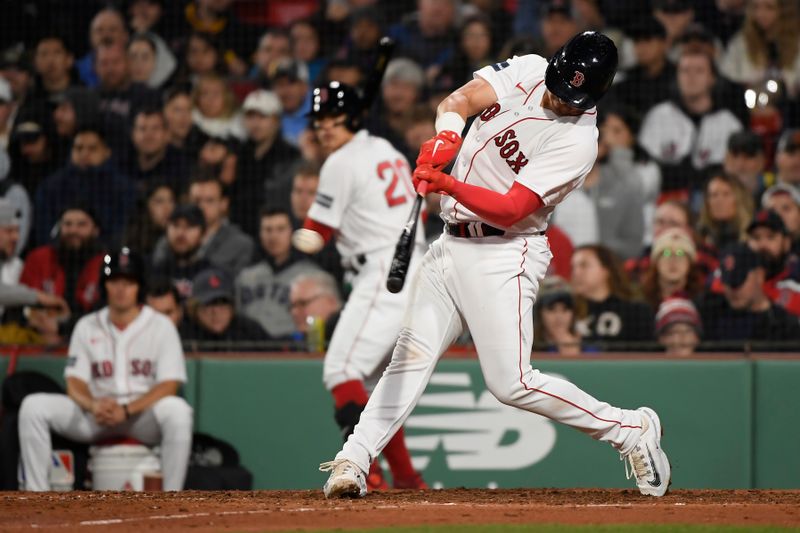 Apr 4, 2023; Boston, Massachusetts, USA;  Boston Red Sox catcher Reese McGuire (3) hits a double during the seventh inning against the Pittsburgh Pirates at Fenway Park. Mandatory Credit: Bob DeChiara-USA TODAY Sports