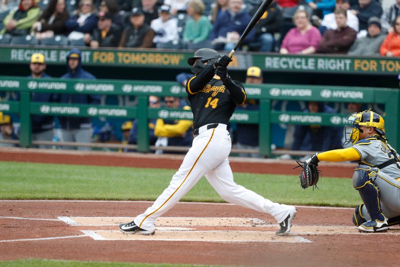 Apr 25, 2024; Pittsburgh, Pennsylvania, USA;  Pittsburgh Pirates catcher Joey Bart (14) hits a three run home run against the Milwaukee Brewers during the first inning at PNC Park. Mandatory Credit: Charles LeClaire-USA TODAY Sports