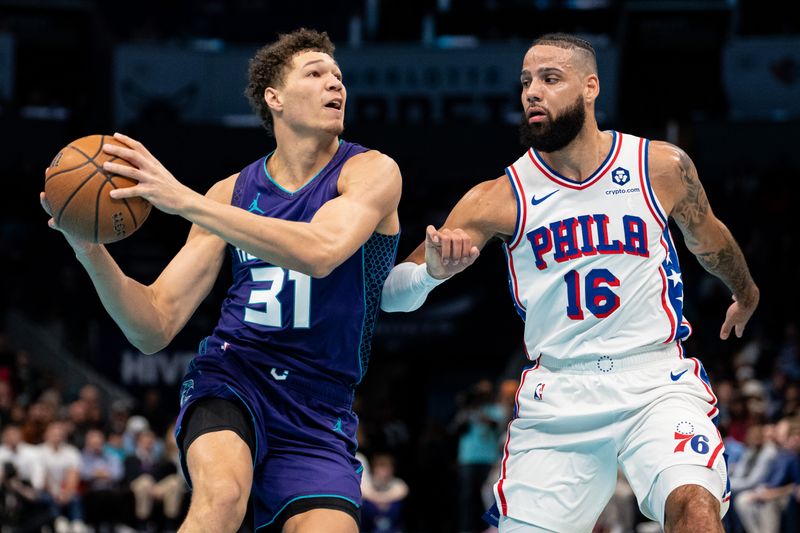 CHARLOTTE, NORTH CAROLINA - DECEMBER 03: Caleb Martin #16 of the Philadelphia 76ers guards Tidjane Salaun #31 of the Charlotte Hornets in the second quarter of the game during the Emirates NBA Cup at Spectrum Center on December 03, 2024 in Charlotte, North Carolina. NOTE TO USER: User expressly acknowledges and agrees that, by downloading and or using this photograph, User is consenting to the terms and conditions of the Getty Images License Agreement. (Photo by Jacob Kupferman/Getty Images)